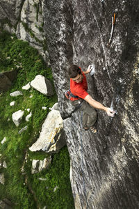 High angle view of young man climbing mountain