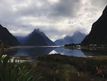 Scenic view of lake and mountains against sky