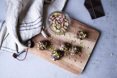 High angle view of chocolate pistachio truffle on cutting board at kitchen counter