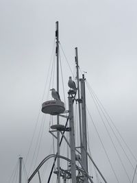 Low angle view of sailboat against clear sky