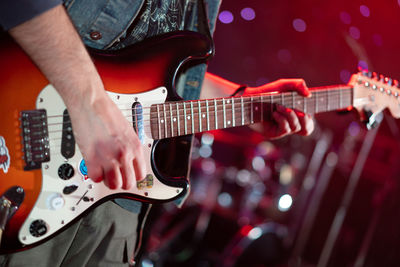 Close up play electric guitar at a rock concert