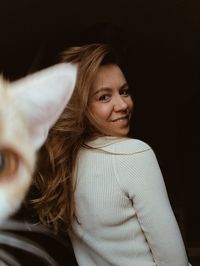 Portrait of smiling girl in black background