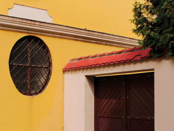 Low angle view of yellow window on building