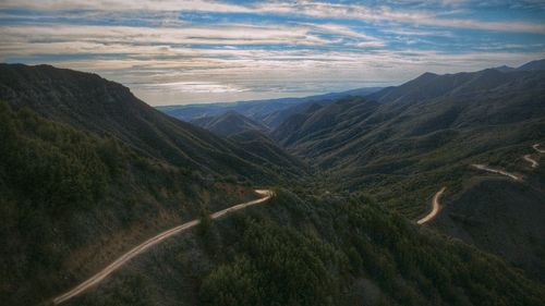 Scenic view of mountains against cloudy sky