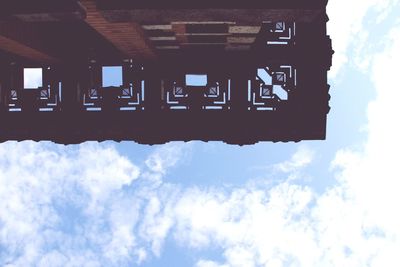 Silhouette houses against cloudy sky