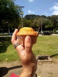 Close-up of hand holding muffin