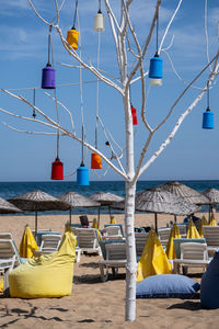 Lounge chairs on beach against sky