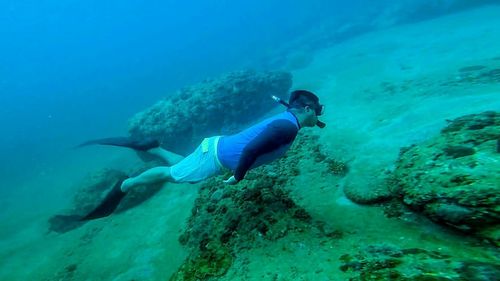 Side view of man snorkeling in sea