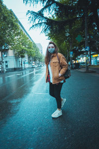 Full length of woman walking on road in city