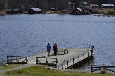 Rear view of people walking on pier