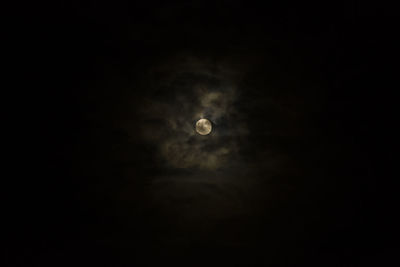 Low angle view of moon in the dark