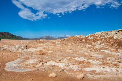 Scenic view of desert against blue sky