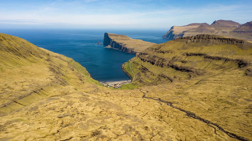 Scenic view of sea and mountains against sky