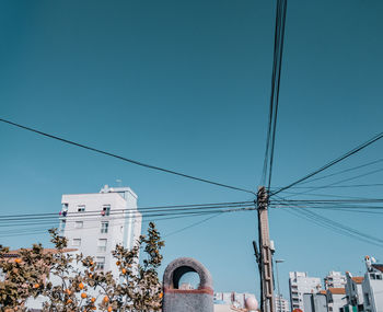 Low angle view of buildings against clear blue sky