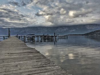 Pier on beach against sky