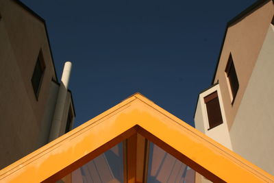 Low angle view of yellow building against clear sky