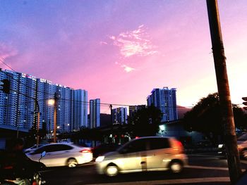 Illuminated cityscape against sky at night