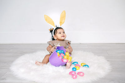 Cute smiling girl sitting on carpet