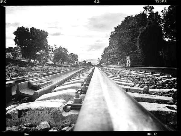 railroad track, transportation, transfer print, rail transportation, tree, diminishing perspective, the way forward, auto post production filter, vanishing point, sky, public transportation, railway track, mode of transport, built structure, day, no people, travel, outdoors, metal, cloud - sky