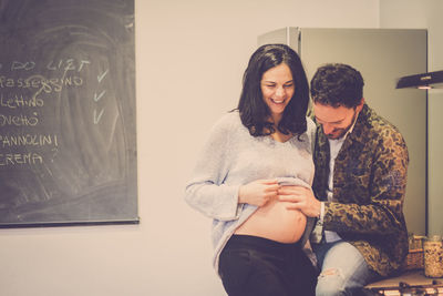 Man touching stomach of pregnant woman