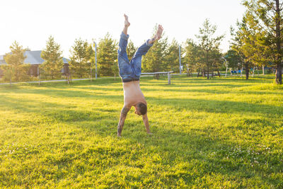 Full length of man jumping on field