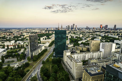 Warsaw, city centre panorama at sunset, business centre 2022. sunset reflected in buildings.