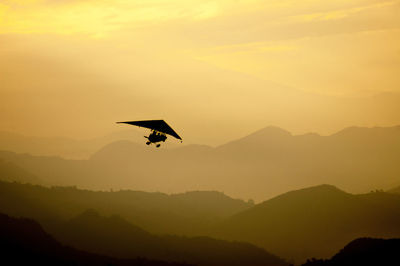 A small plane flying in the morning over the annapurna range mountains of himalayas.