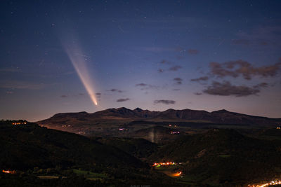 Scenic view of mountains against sky at night