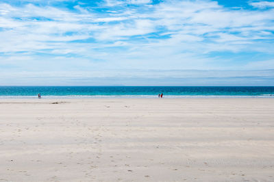 People on beach against sky