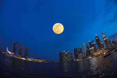 Full frame shot of modern buildings against sky at night