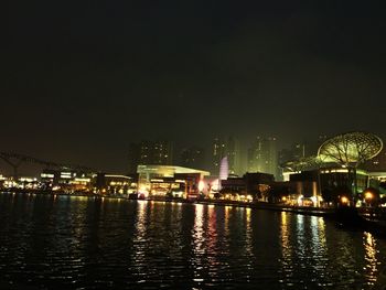 View of illuminated city against clear sky at night