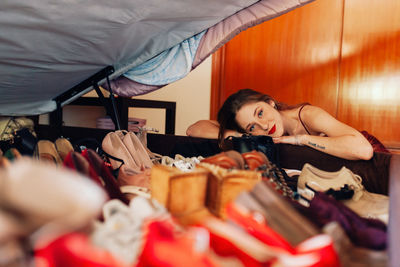 Portrait of woman lying on bed