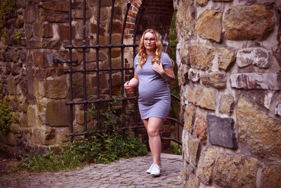 Woman standing against wall