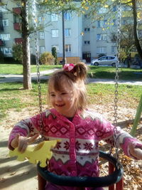 Portrait of cute girl smiling against plants