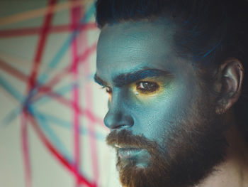 Close-up of serious man with painted face