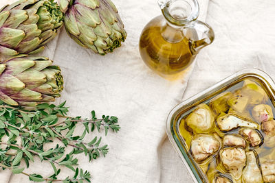 Artichokes hearts marinated with olive oil and herbs.pickled artichoke with in glass bowl on table