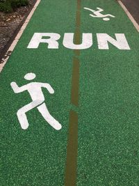 High angle view of arrow sign on road