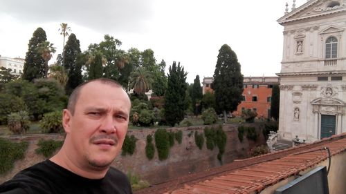 Portrait of man looking away against sky