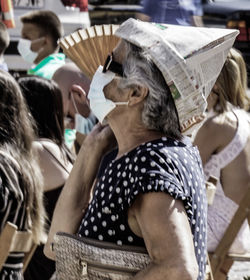 Rear view of people sitting on book