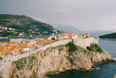 Scenic view of sea and buildings against sky