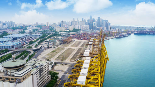 High angle view of river amidst buildings against sky