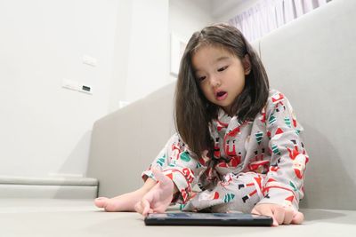 Girl looking away while sitting at home