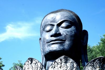 Low angle view of statue against blue sky