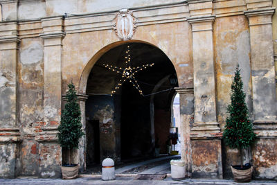 Historic stone wall archway entrance with christmas star in italy