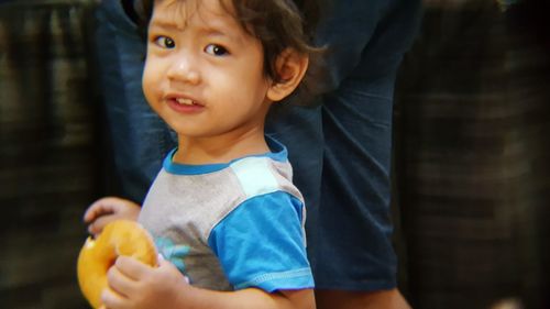 Portrait of cute boy eating fruit