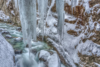 Scenic view of waterfall in forest during winter