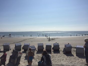 People on beach against sky