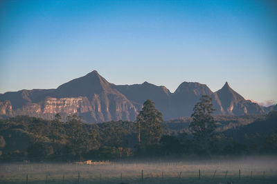 Scenic view of mountains against clear blue sky