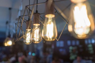 Low angle view of illuminated light bulb hanging