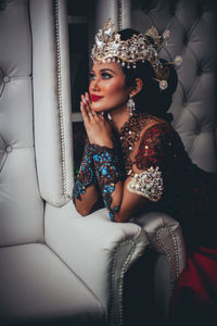 Portrait of a young woman sitting outdoors